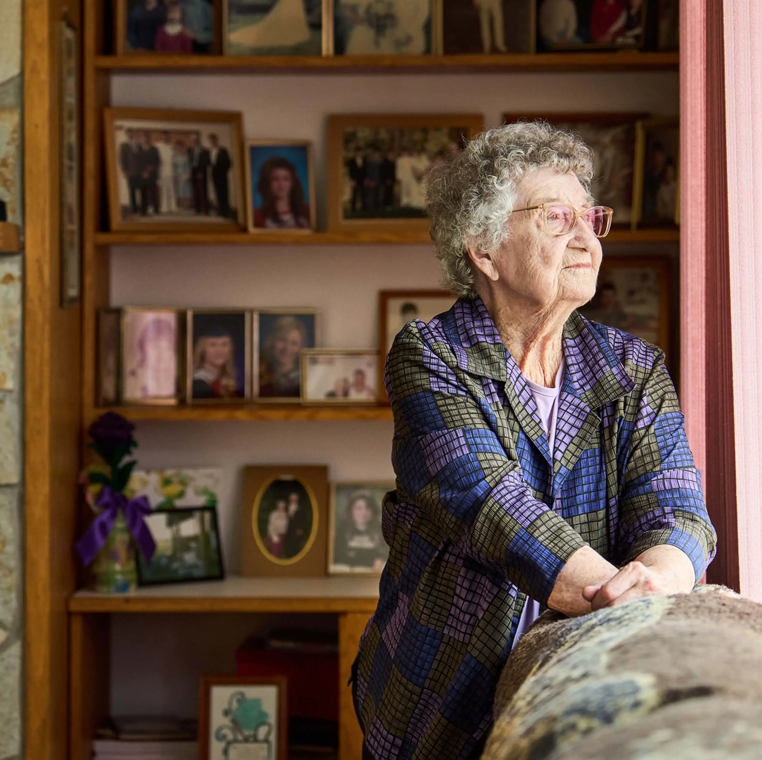 Senior woman with photo collection background