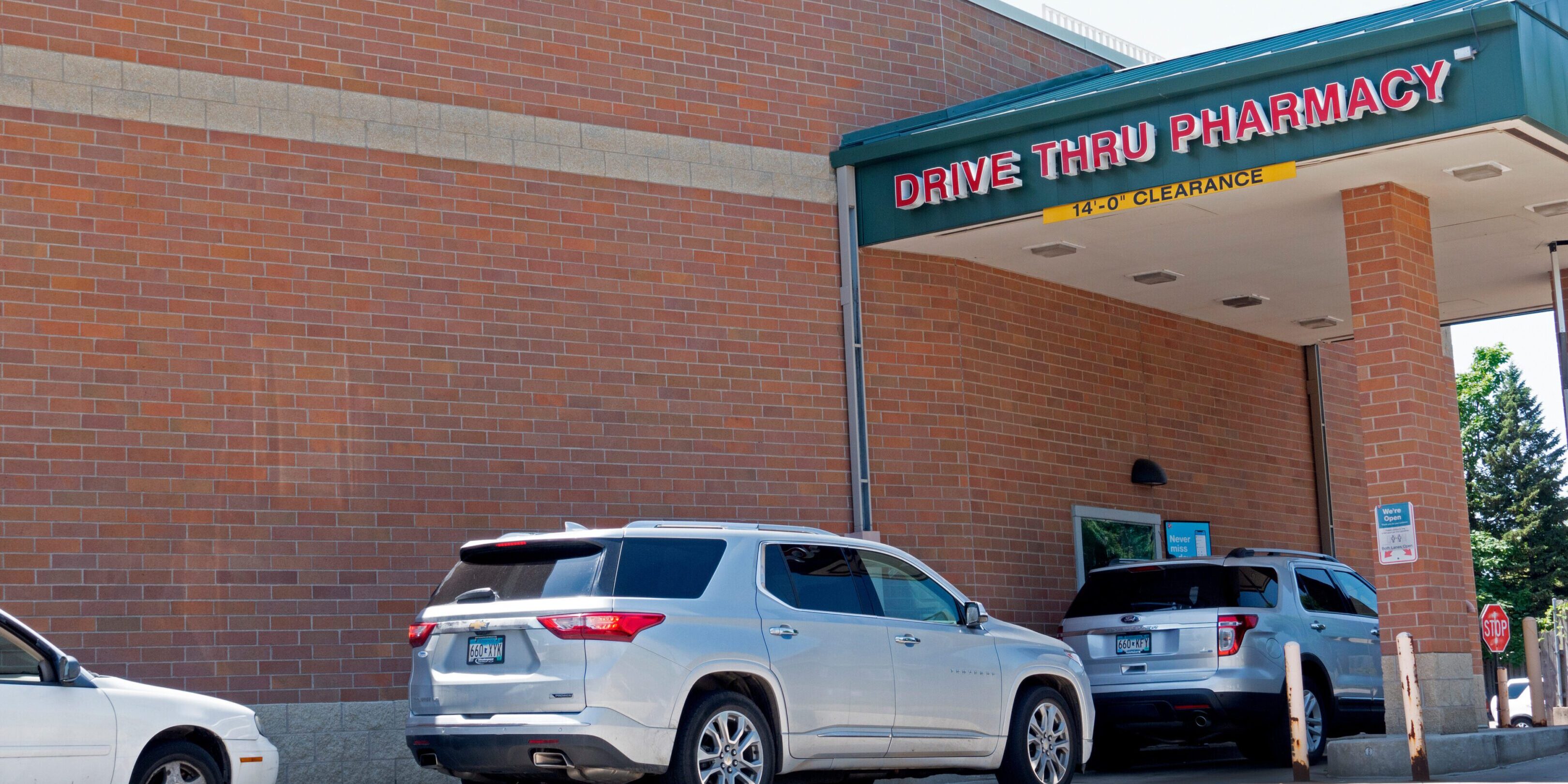 Cars are lined up to pick up pharmaceuticals in the drive through at Walgreens.  St Paul Minnesota MN USA